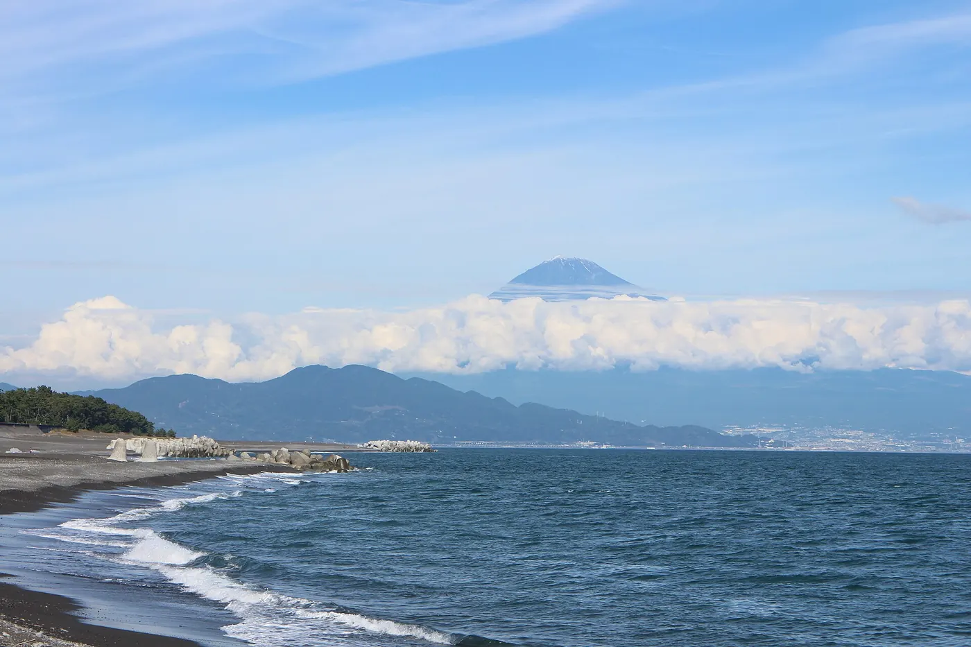 Waves on the black-sand beach at Miho with Mt. Fuji across Suruga Bay