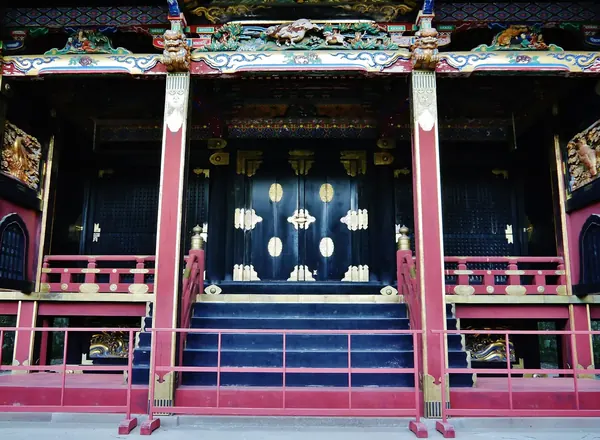 A lacquered gate within the shrine complex