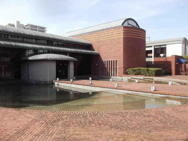 The brick Verkehr Museum and its courtyard pool